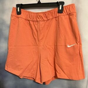 Nike women’s high waist loose fit shorts, orange w/white swoosh, pockets NWT L